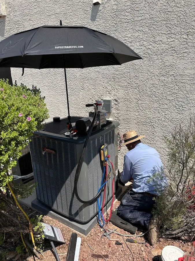 HVAC technician performing outdoor AC maintenance in East Vincent