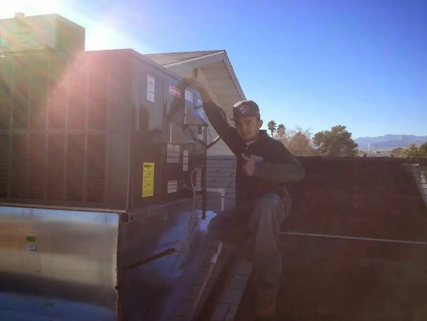 HVAC technician performing HVAC Inspection on a rooftop unit in East Vincent